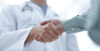 closeup.handshake between doctor and patient.Caucasian
